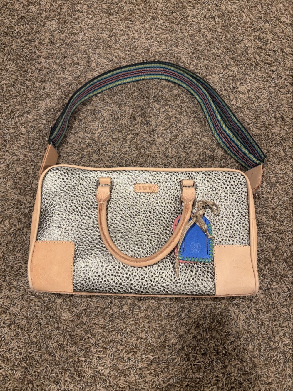 Consuela Tommy Satchel With a textured gold exterior & natural leather handles